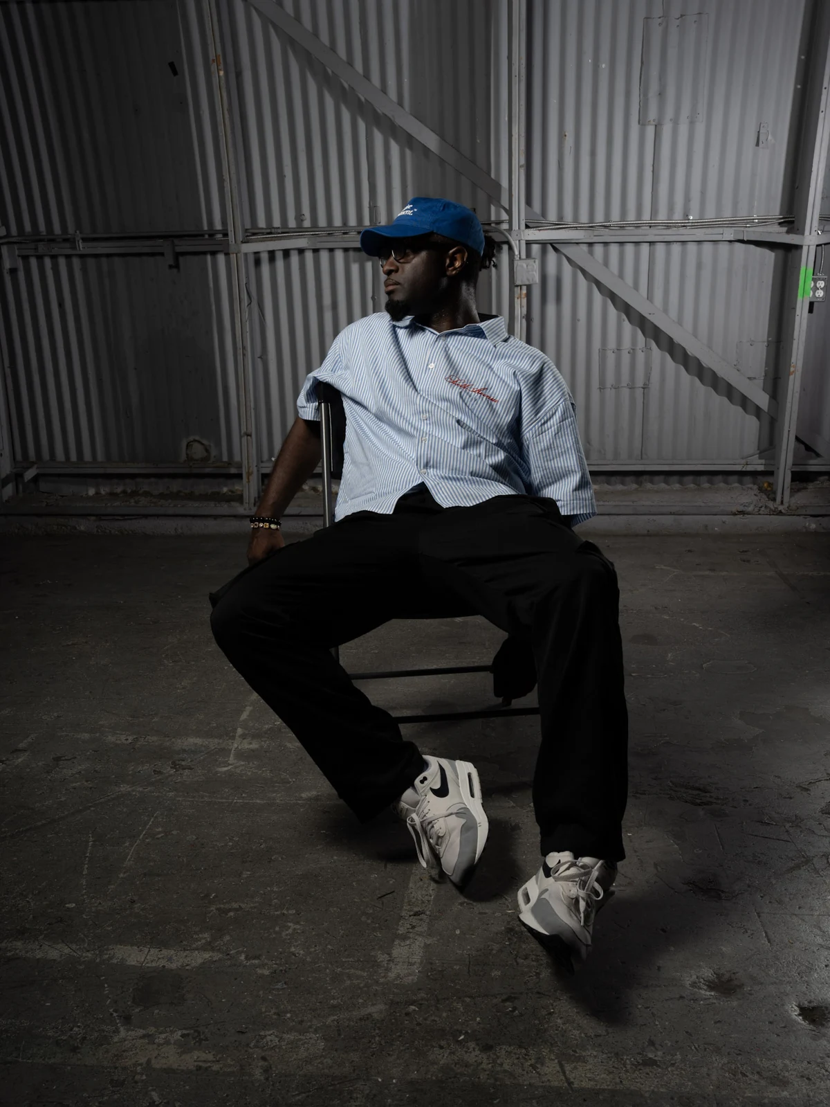 Jordain Johnson seated in a blue cap and striped shirt